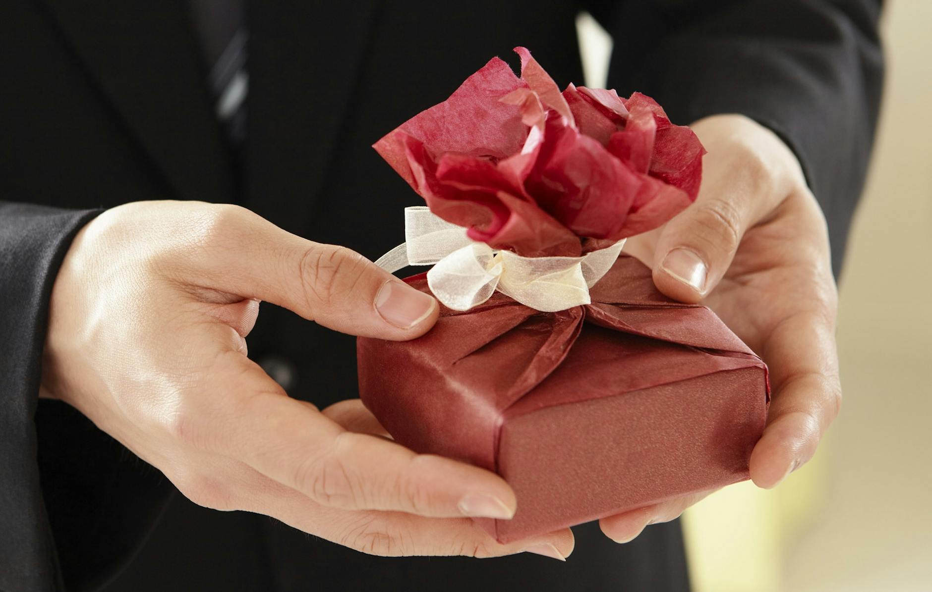person holding box with red wrapper